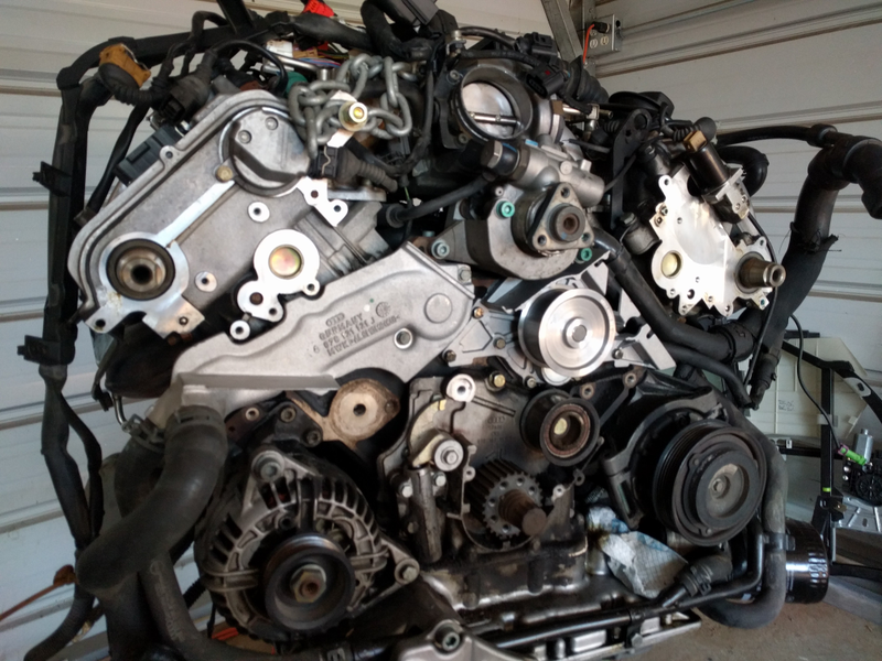 Timing belt and cam gears off, t-stat housing and water pump on. I love shiny new parts.
